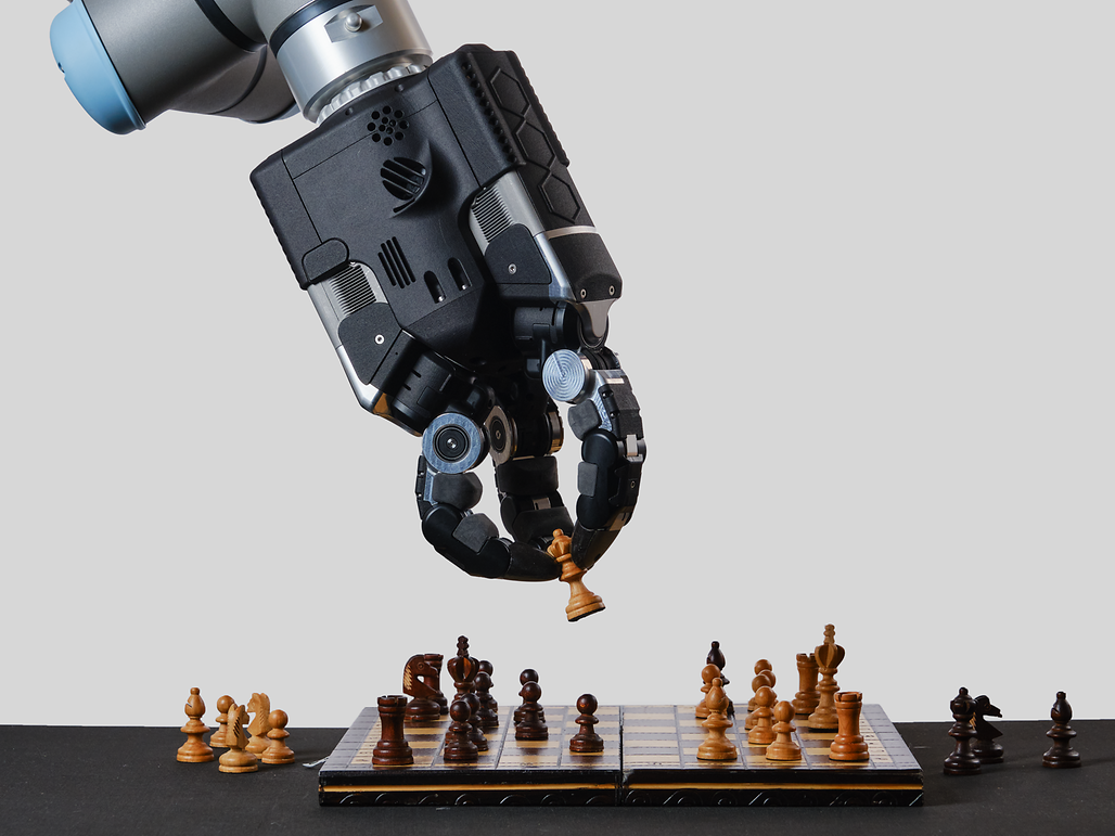 A robot playing chess, focused on the board as it strategizes its next move in the game.