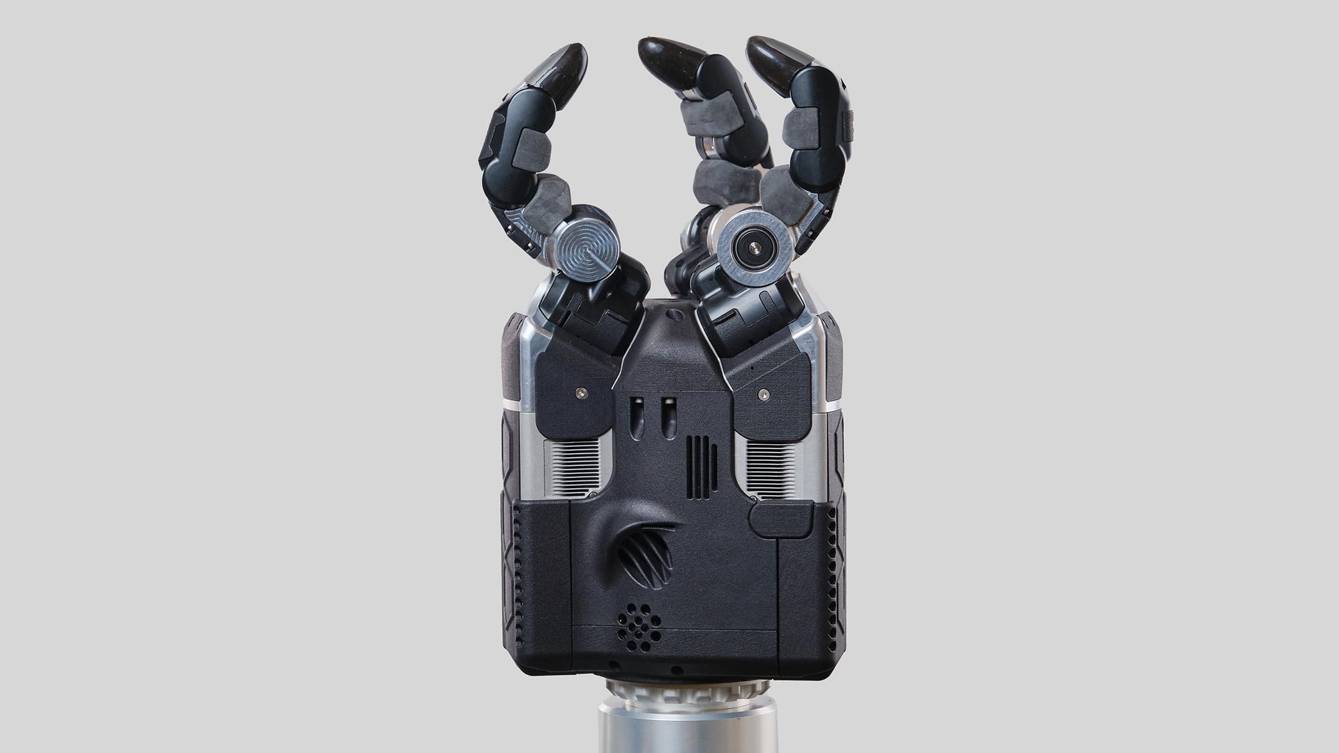 A close-up of a robotic hand featuring three fingers prominently positioned on top, showcasing advanced technology.